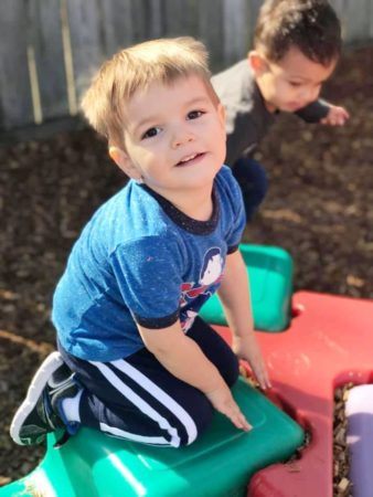 preschool_boy_playing_on_playground_equipment_cadence_academy_preschool_summerville_sc-338x450