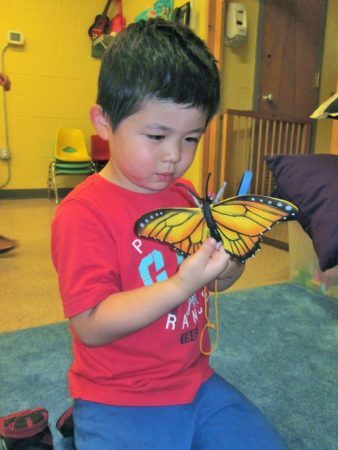 preschool_boy_playing_with_butterfly_toy_prime_time_early_learning_centers_east_rutherford_nj-338x450