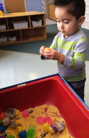 preschool_boy_playing_with_eggs_and_sand_at_next_generation_childrens_centers_westborough_ma-291x450