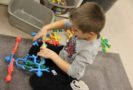 preschool_boy_playing_with_interlocking_plastic_men-cadence_academy_preschool_clive_ia-667x450