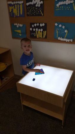 preschool_boy_playing_with_light_box_cadence_academy_preschool_austin_cedar_park_tx-253x450