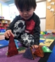 preschool_boy_playing_with_magnetic_triangles_cadence_academy_preschool_east_greenwich_ri-394x450