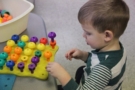preschool_boy_playing_with_peg_game_cadence_academy_preschool_ankeny_ia-675x450