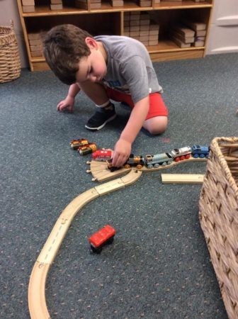 preschool_boy_playing_with_trains_at_next_generation_childrens_centers_franklin_ma-336x450