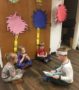 preschool_boy_reading_dr_seuss_to_classmates_childrens_garden_montessori_richland_wa-396x450