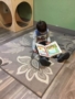 preschool_boy_reading_letter_book_cadence_academy_preschool_cooper_point_olympia_wa-338x450