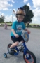 preschool_boy_riding_bike_during_st_jude_trike-a-thon_canterbury_academy_at_prairie_ridge_olathe_ks-286x450