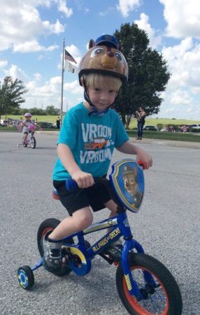 preschool_boy_riding_bike_during_st_jude_trike-a-thon_canterbury_academy_at_prairie_ridge_olathe_ks-286x450