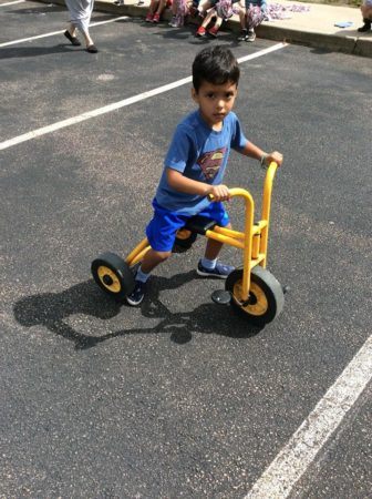 preschool_boy_riding_tricycle_in_parking_lot_at_next_generation_childrens_centers_walpole_ma-336x450