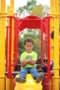 preschool_boy_sitting_on_playground_cadence_academy_preschool_rosemeade_carrollton_tx-300x450