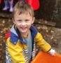 preschool_boy_smiling_on_the_playground_at_cadence_academy_preschool_sellwood_portland_or-435x450