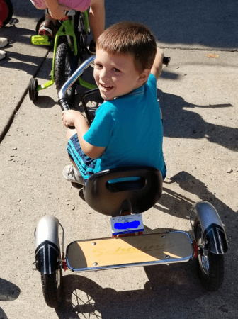 preschool_boy_smiling_on_tricycle_rogys_learning_place_east_peoria_il-336x450