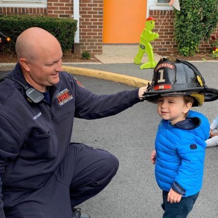 preschool_boy_trying_on_a_fire_fighter_hat_prime_time_early_learning_centers_edgewater_nj-450x450