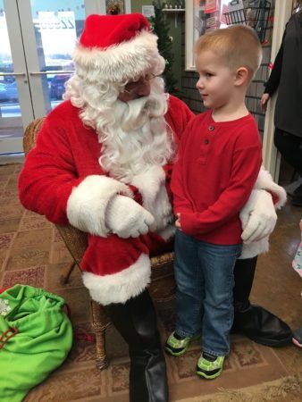 preschool_boy_visiting_with_santa_canterbury_academy_at_shawnee_crossings_shawnee_ks-338x450