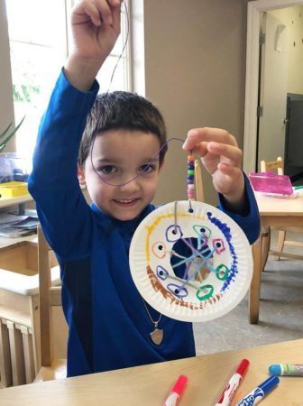 preschool_boy_with_completed_dream_catcher_cadence_academy_preschool_tumwater_wa-336x450