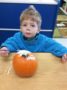 preschool_boy_with_paint_on_lip_and_pumpkin_cadence_academy_preschool_myrtle_beach_sc-336x450