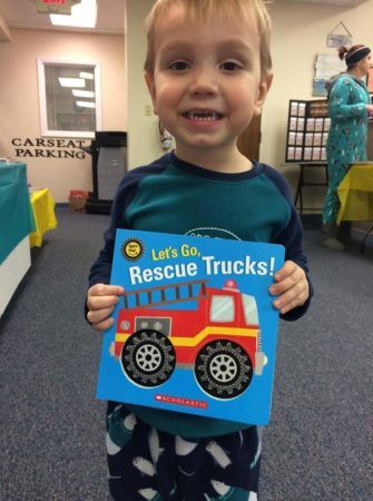preschool_boy_with_rescue_trucks_book_cadence_academy_chesterfield_mo-335x450