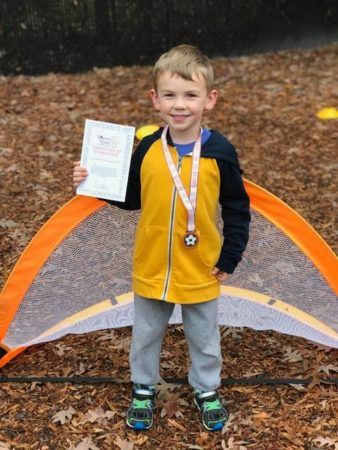 preschool_boy_with_soccer_shots_certificate_winwood_childrens_center_reston_va-338x450