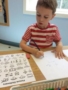 preschool_boy_working_on_picture_dictionary_next_generation_childrens_centers_andover_ma-338x450