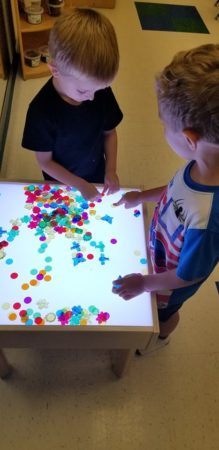 preschool_boys_playing_at_light_table_winwood_childrens_center_gainesville_ii_va-219x450