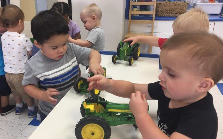 preschool_boys_playing_with_john_deere_tractors_at_phoenix_childrens_academy_private_preschool_thunderbird-719x450