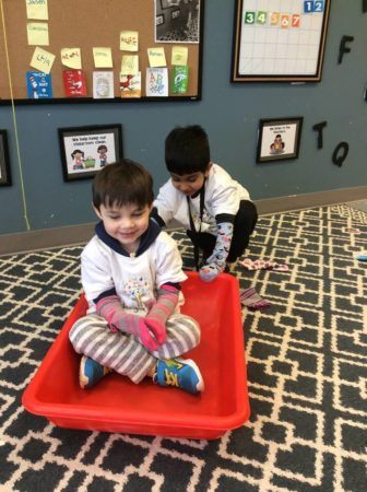 preschool_boys_playing_with_sled_inside_jonis_child_care_preschool_farmington_ct-336x450