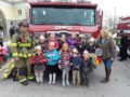 preschool_children_and_teacher_standing_in_front_of_fire_truck_canterbury_preparatory_school_overland_park_ks-600x450