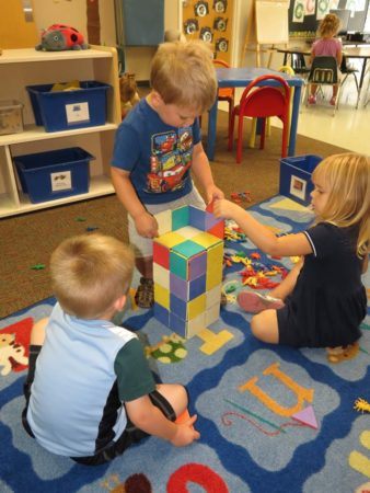 preschool_children_building_a_block_tower_at_cadence_academy_collegeville_pa-338x450