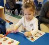 preschool_children_cutting_with_scissors_at_cadence_academy_preschool_northeast_columbia_sc-488x450