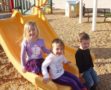 preschool_children_going_down_slide_cadence_academy_preschool_carmichael_ca-555x450