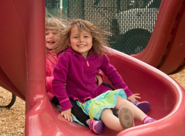 preschool_children_going_down_slide_cadence_academy_preschool_sherwood_or-613x450