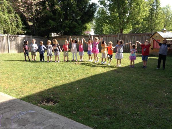 preschool_children_holding_hands_on_playground_cadence_academy_preschool_dupont_wa-600x450