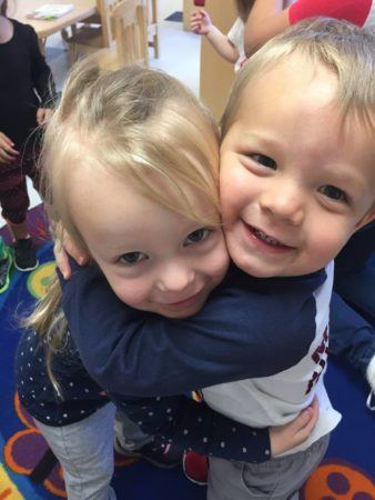 preschool_children_hugging_cadence_academy_preschool_the_colony_tx-338x450