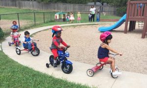 preschool_children_on_tricycles_at_cadence_academy_preschool_grand_prairie_tx-752x450