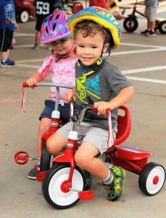 preschool_children_on_tricycles_carolina_kids_child_development_center_fort_mill_sc-344x450