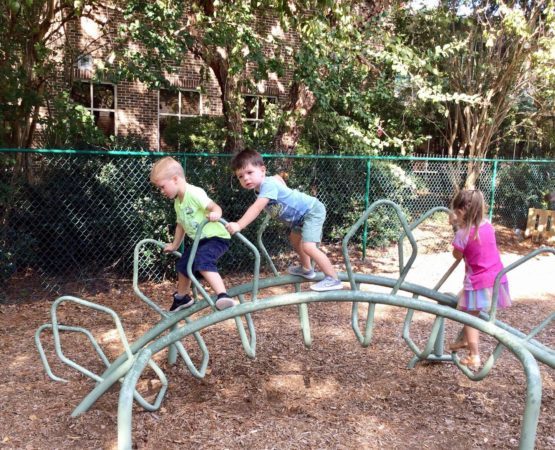 preschool_children_playing_on_dinosaur_playground_equipment_cadence_academy_preschool_mount_pleasant_sc-555x450