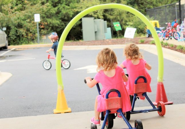 preschool_children_riding_tricycles_at_carolina_kids_child_development_center_fort_mill_sc-645x450