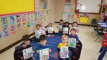 preschool_children_showing_off_their_cat_in_the_hat_paintings_cadence_academy_preschool_leon_springs-752x423