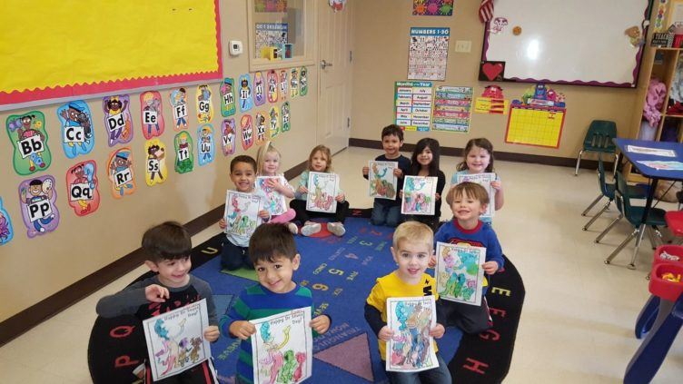 preschool_children_showing_off_their_cat_in_the_hat_paintings_cadence_academy_preschool_leon_springs-752x423