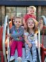 preschool_children_sitting_on_slide_at_cadence_academy_preschool_the_colony_tx-338x450