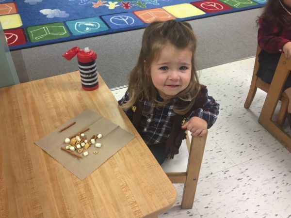 preschool_cowgirl_enjoying_trail_mix_smaller_scholars_montessori_academy_grisby_tx-600x450