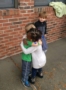 preschool_friends_hugging_outside_cadence_academy_preschool_myrtle_beach_sc-328x450