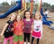 preschool_friends_on_playground_cadence_academy_preschool_wilmington_nc-555x450