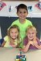 preschool_friends_posing_in_front_of_legos_winwood_childrens_center_lansdowne_va-305x450