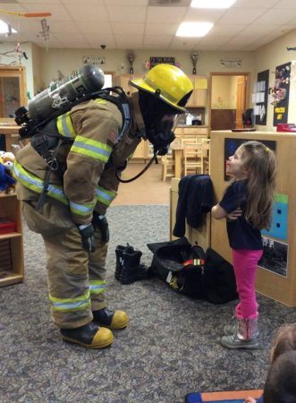 preschool_girl_and_firefighter_cadence_academy_preschool_sleater-kinney_olympia_wa-331x450