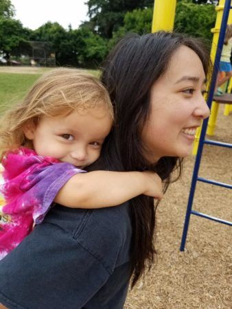 preschool_girl_and_teacher_on_playground_cadence_academy_preschool_milwaukie_portland_or-338x450