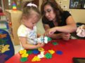 preschool_girl_and_teacher_playing_with_blocks_cadence_academy_preschool_smoky_hill_aurora_co-604x450