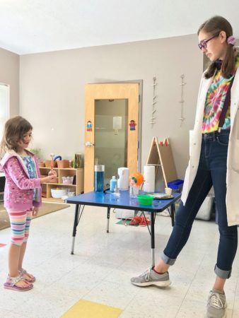 preschool_girl_and_teacher_science_activity_gateway_academy_mckee_charlotte_nc-338x450