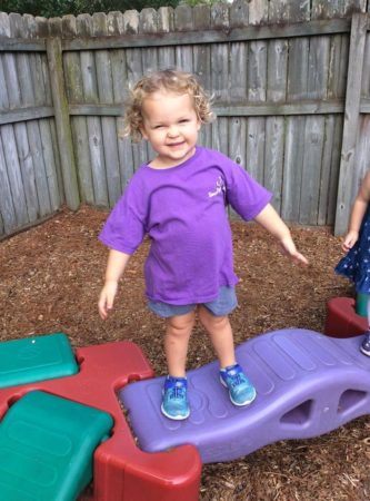 preschool_girl_balancing_on_bridge_cadence_academy_preschool_summerville_sc-333x450