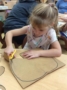 preschool_girl_cutting_out_pumpkin_creative_expressions_learning_center_eureka_mo-337x450